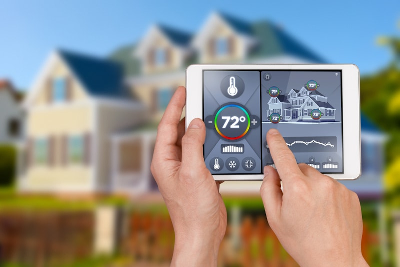 person operating smart thermostat from tablet