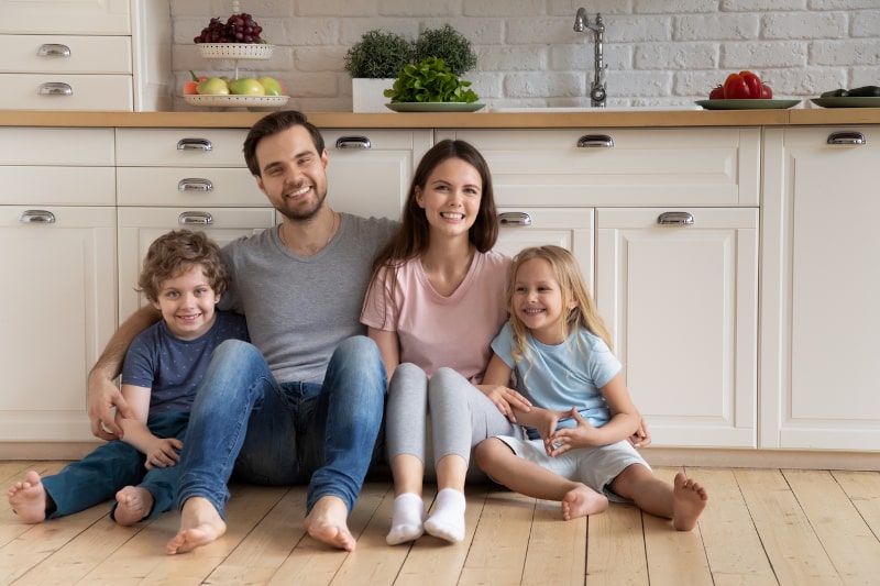 Smiling Family On Kitchen Floor